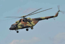 $210 MILLION Rescue — Special HERO “KILLER EGG” Camouflage military helicopter in flight against blue sky.