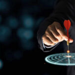 Another Precise STRIKE—Iran’s Spy Chief DEAD Hand aiming dart at digital target.