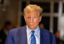 Trump ATTACKS Pope — Explosive Vatican War Erupts Man in blue suit and striped tie, serious expression.