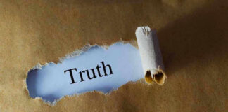 Ripped paper reveals word truth underneath brown surface