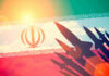 HORROR Manual EXPOSED–Iran’s REAL Narrative Silhouettes of missiles over Irans flag graphic.