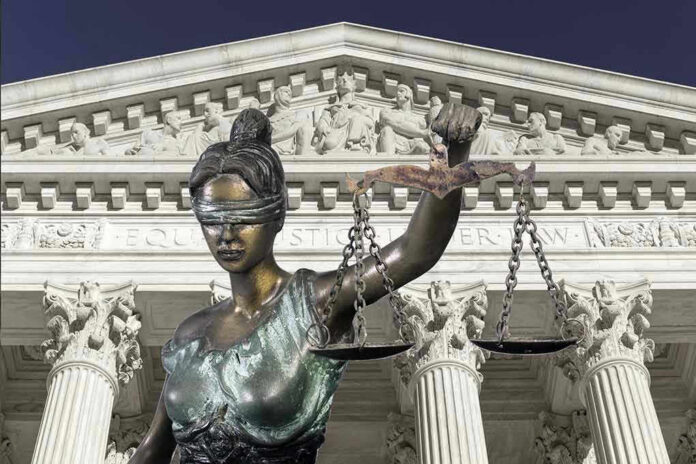 Lady Justice statue in front of courthouse.