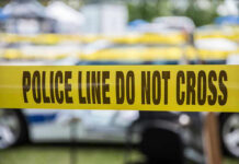 Yellow police line tape with Do Not Cross.