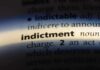 Close-up of a dictionary page showing the definition of 'indictment'