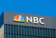 ICE Arrests 185,000—NBC HIDES Critical Detail NBC logo displayed on a corporate building against a blue sky