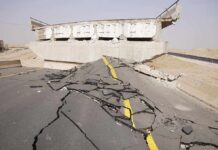 Severely damaged road and collapsed bridge due to earthquake