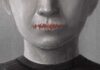 A human figure with stitched lips, symbolizing silence or repression