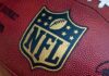 DOJ’s Spotlight on NFL–SHOWDOWN LOOMS Close-up of an NFL football with the logo prominently displayed
