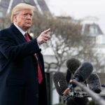 Donald Trump gesturing while speaking to the press outside