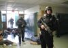 Police officers responding to a school emergency with students on the floor