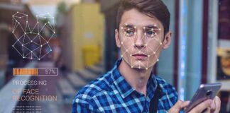 Young man using a smartphone with face recognition overlay