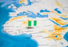 Flag pin marking Nigeria on Africa map.