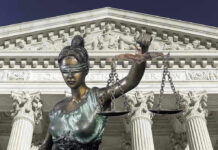 Explosive Settlement Talks: Trump’s $10 Billion Gambit Lady Justice statue in front of courthouse.