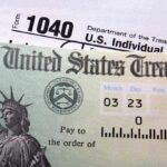 IRS in Chaos — Millions Could RECLAIM Penalties! Close-up of a U.S. Treasury check and tax form 1040
