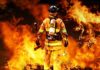 CO Alarm Ignored—Massive Tragedy Strikes Firefighter standing in front of a large fire, equipped with tools