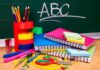 A collection of colorful school supplies including notebooks, pens, and scissors on a desk