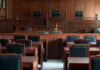 Houston Court Decisions Backfire — Tragedy Follows Empty courtroom with wooden furnishings and judges bench.