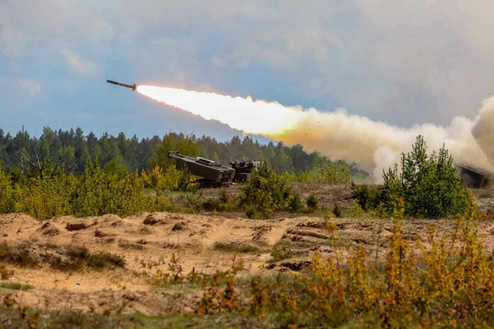 1302196150 Military tank firing a missile in forest area.