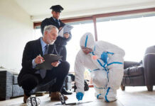 Forensic team examining evidence at a crime scene indoors.