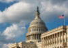 Tariff Hammer Looms Over Europe US Capitol Building with American flags and clouds