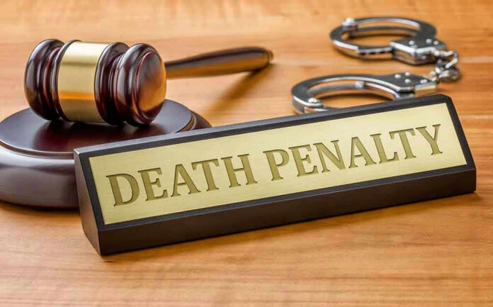 Gavel, handcuffs, and Death Penalty sign on desk.