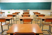 Bible In Classrooms — Texas Lights Legal Fuse Empty classroom with desks and a chalkboard.