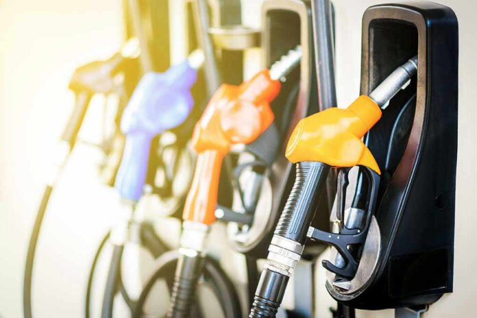 556957450 Colorful gas pump nozzles at a station.
