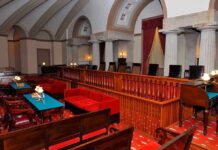 Court Upends Federal Sports Push Interior of a historic courtroom featuring wooden furniture and elegant decor