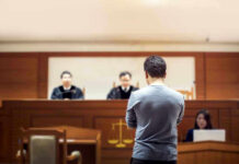 Former National Security Adviser Pleads Guilty Man stands in courtroom before judges and stenographer.
