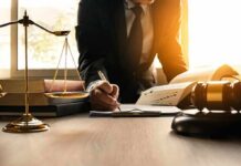 State Law Trumps Sharia Divorce Claims Lawyer writing at desk with scales and gavel