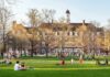 Students Hail Killer — Regents Push Back Students relaxing on a campus quad in front of a brick academic building