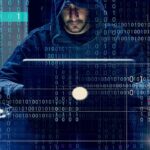 Millions of Scam Texts Start Here Person in hoodie using a laptop with binary code overlay