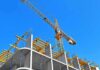 Tower crane over concrete building under construction