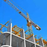 Tower crane over concrete building under construction
