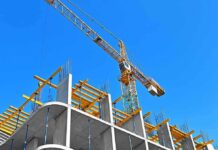 Tower crane over concrete building under construction