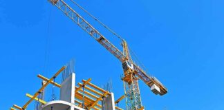Tower crane over concrete building under construction