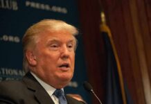 Digital Tax? TRUMP Doubles Every Import A public figure speaking at a podium during a press conference
