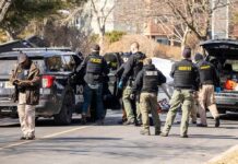 Alabama Couple’s Deaths Spark Investigation Police and sheriff officers gather around vehicles on a suburban street