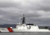 Suspected Iranian Drone Rattles Tanker Lane A U.S. Coast Guard ship docked under cloudy skies