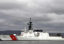 Suspected Iranian Drone Rattles Tanker Lane A U.S. Coast Guard ship docked under cloudy skies
