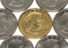 A collection of coins featuring a gold coin surrounded by silver coins