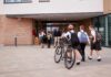 Students in uniforms arriving at a school entrance