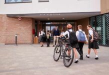Students in uniforms arriving at a school entrance