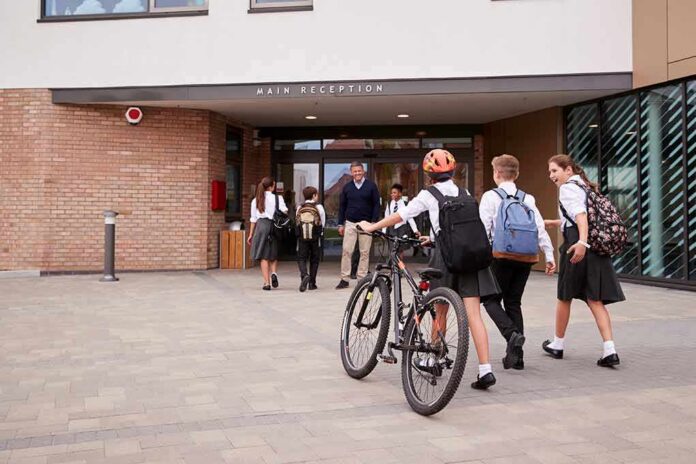 Students in uniforms arriving at a school entrance