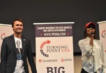Two speakers on stage at a Turning Point USA event