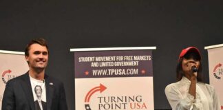 Two speakers on stage at a Turning Point USA event