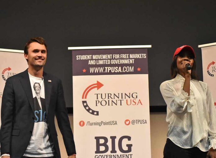 shutterstock_1232510308 Two speakers on stage at a Turning Point USA event