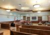 Empty courtroom with wooden benches and judge's bench