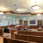 Empty courtroom with wooden benches and judge's bench