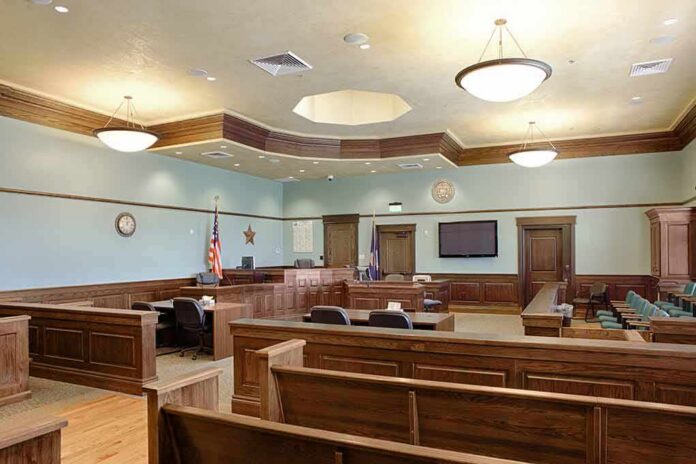 Empty courtroom with wooden benches and judge's bench